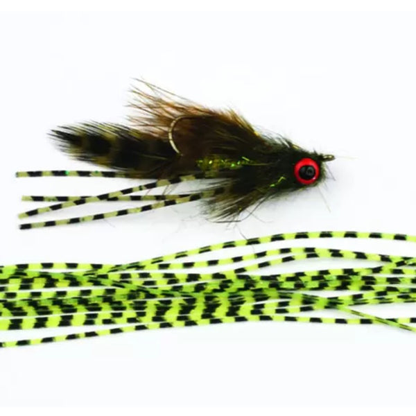 Several lengths of Perfectly Barred Wapsi Sili Legs for fly tying shown next to a streamer tied with these legs on a white background.