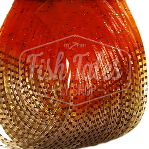 Sand and orange Perfectly Barred Fire Tip Wapsi Sili Legs for fly tying shown close up on a white background.