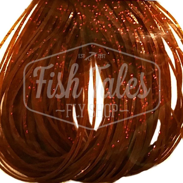 Brown with orange flake Speckled Flake Wapsi Sili Legs for fly tying shown close up on a white background.