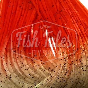 Clear with orange Fire Tip Wapsi Sili Legs for fly tying shown close up on a white background.