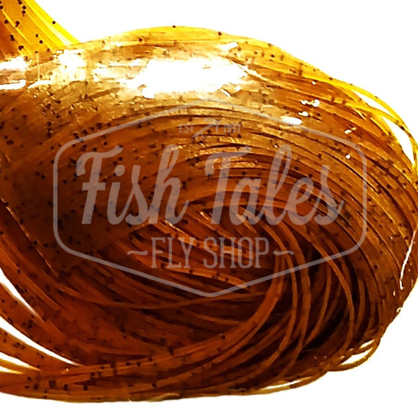 Pumpkin with black Speckled Flake Wapsi Sili Legs for fly tying shown close up on a white background.
