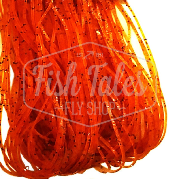 Orange with orange and black flake Speckled Flake Wapsi Sili Legs for fly tying shown close up on a white background.