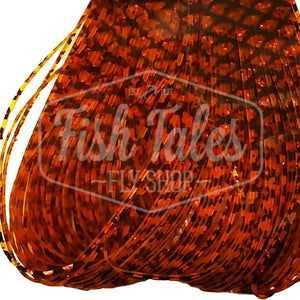 Orange and black Scale Barred Wapsi Sili Legs for fly tying shown close up on a white background.