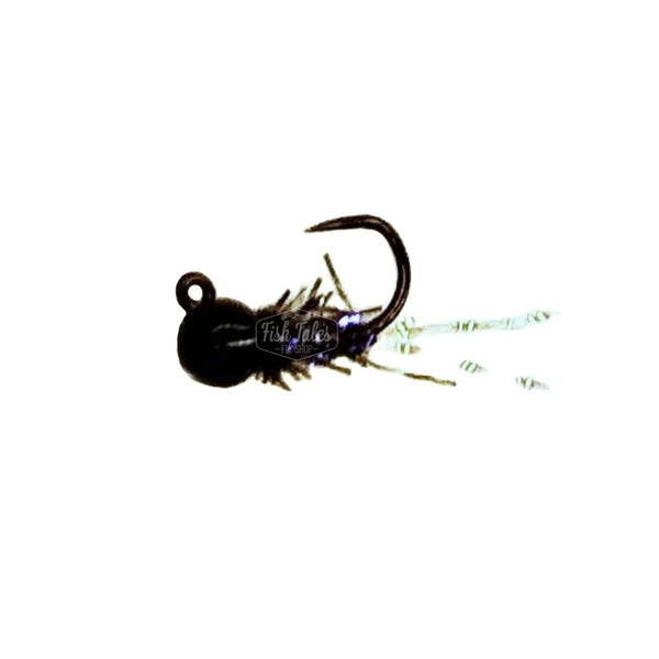 A Will's Chai Tea Jig Nymph fly with a black bead head, black synthetic material body and tied on a jig style hook over a white background.