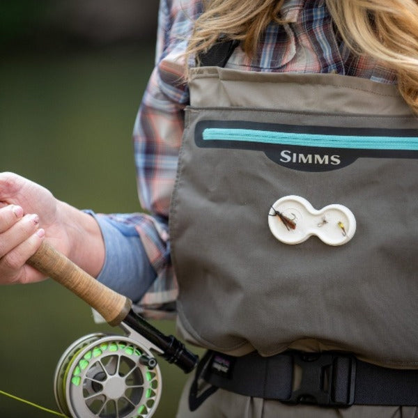 A person using a fly fishing rod with the Backcountry Labs Duo Magnetic fly holders on the front of waders.