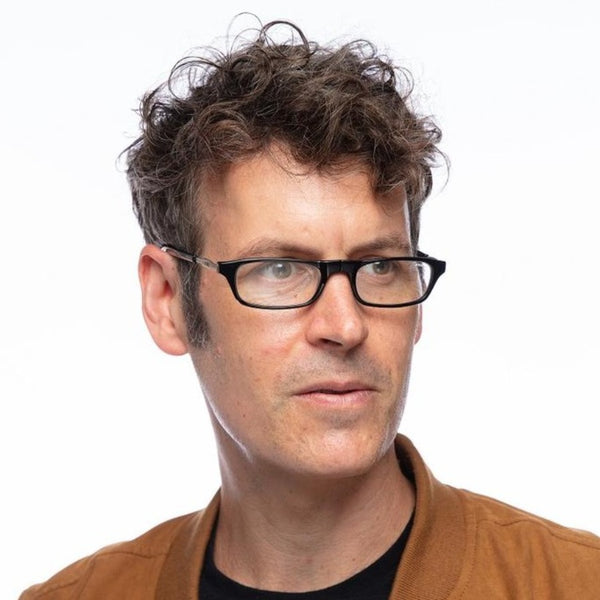 bust of a man wearing one set of click orginal readers on a white background