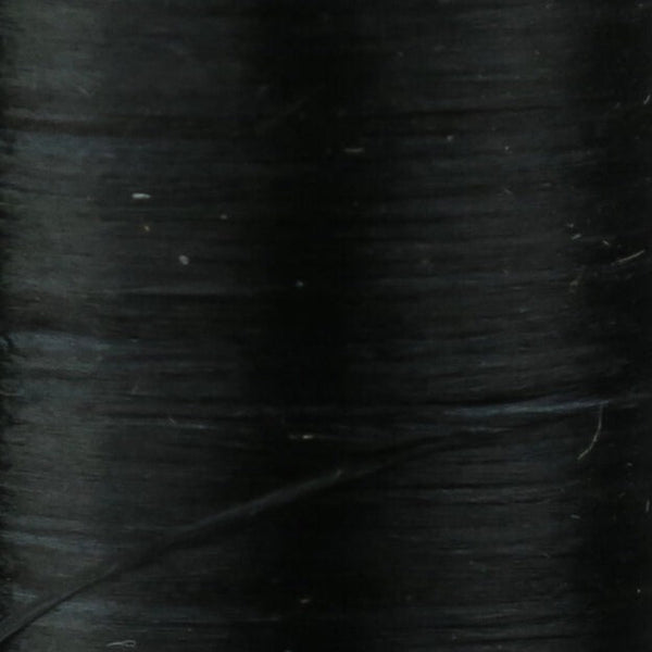 Close up of black Danville Flat Waxed Nylon fly tying thread.
