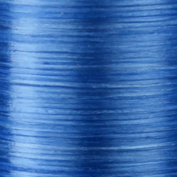 Close up of fluorescent blue Danville Flat Waxed Nylon fly tying thread.