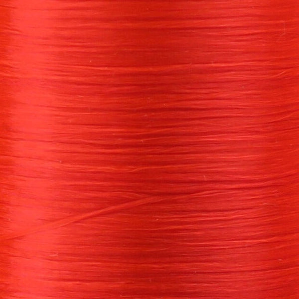 Close up of fluorescent fire orange Danville Flat Waxed Nylon fly tying thread.