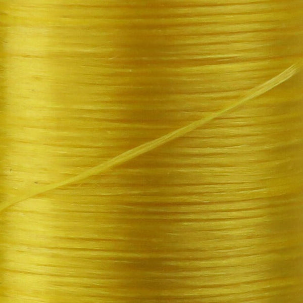 Close up of yellow Danville Flat Waxed Nylon fly tying thread.
