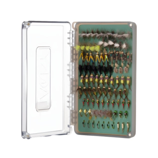 Fishpond Tacky Daypack Fly Box in packaging, in the original blue green color with clear lid, open and showing several fishing flies in the inserts, on a white background.