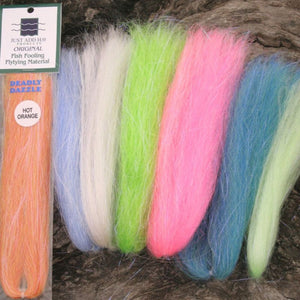 Assorted colors Just Add H2O Deadly Dazzle fly tying material on a wood grain background.