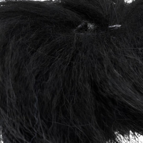 Close up of dyed black arctic fox tail fur used for fly tying.