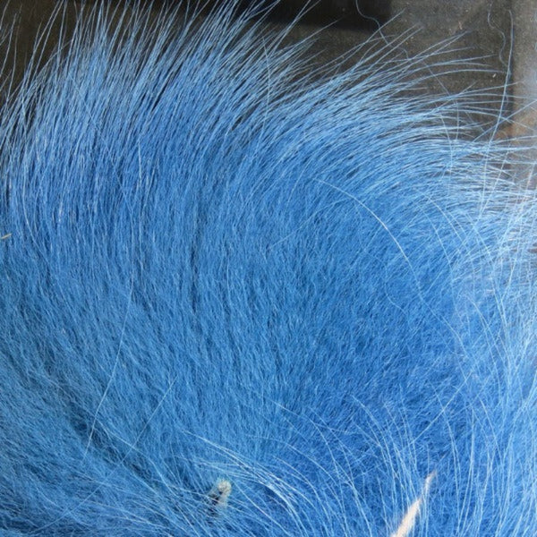 Close up of dyed kingfisher blue arctic fox tail fur used for fly tying.