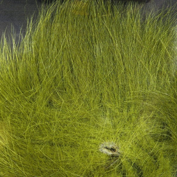 Close up of dyed olive arctic fox tail fur used for fly tying.
