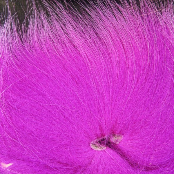 Close up of dyed pink arctic fox tail used for fly tying.