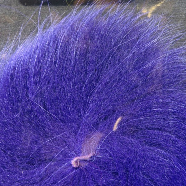 Close up of dyed purple arctic fox tail fur used for fly tying.