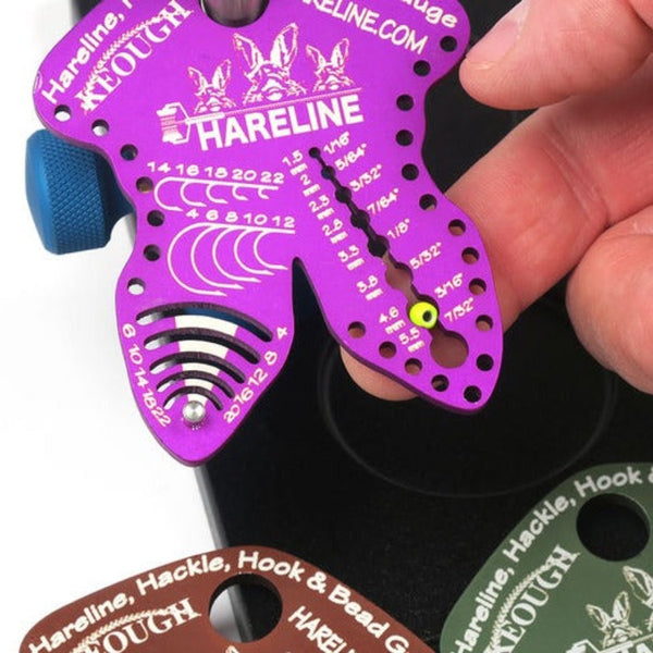 hareline hook hackle bead gauge purple color with hand showing how to use bead measurement