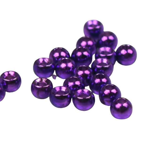 A large group of metallic purple cyclops tungsten beads for fly tying on a white background.