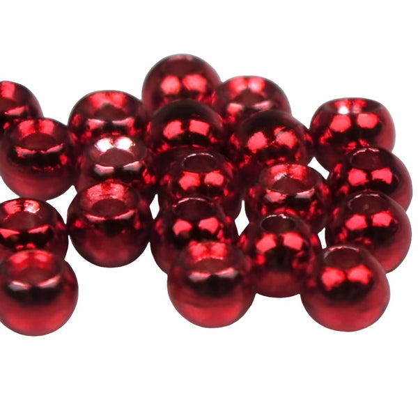 A large group of metallic red cyclops tungsten beads for fly tying on a white background.