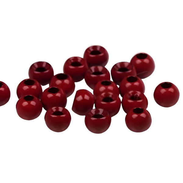 A large group of red cyclops tungsten beads for fly tying on a white background.