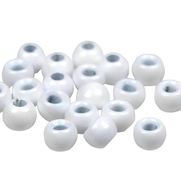 A large group of white cyclops tungsten beads for fly tying on a white background.
