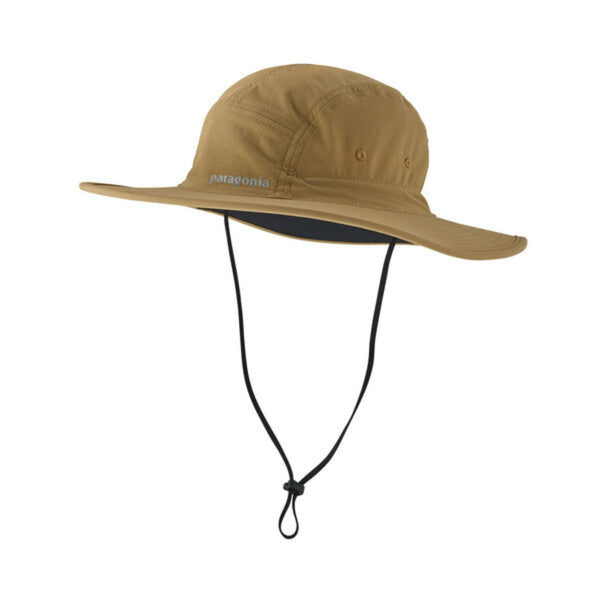 A Patagonia Quandary Brimmer hat in a tan color with a wide brim and an adjustable chin strap, on a white background.