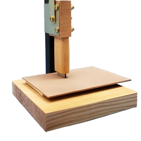 Close up of cutting action of the River Road Creations Cutter Press Assistive Device, showing a cutter pressing into fly tying sheet foam to cut a specific shape, against a white background.