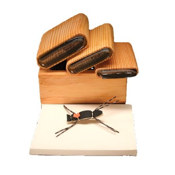 A selection of several sizes of River Road Creations Tapered Chernobyl Foam Body Cutters, shown with the cutting pad and an example tapered body Chernobyl Ant Dry Fly, against a white background. 