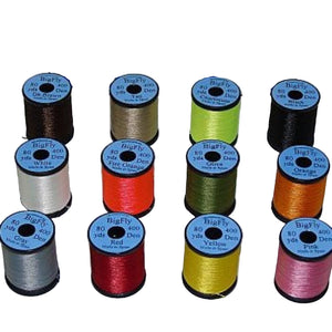 A group of UNI Big Fly fly tying thread spools in a various colors on a white background. 