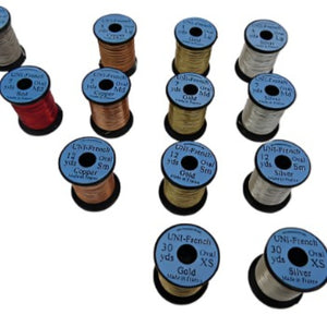 A group of metallic UNI French Oval Tinsel on spools over a white background.