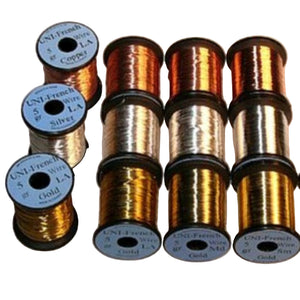 A collection of spools of UNI French Wire in copper, silver, and gold colors, arranged in four sizes: large, medium, small, and extra-small on a white background.